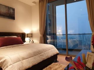 Modern bedroom with a large window and city view