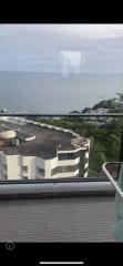 High-rise balcony view of the surrounding area with ocean background