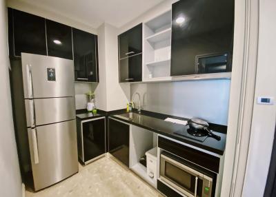 Modern kitchen with stainless steel appliances and black countertops