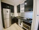 Modern kitchen with stainless steel appliances and black countertops