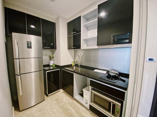 Modern kitchen with stainless steel appliances and black countertops