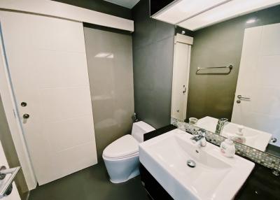 Modern bathroom with white fixtures and sliding door