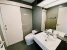 Modern bathroom with white fixtures and sliding door