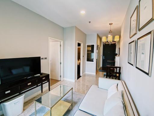 Bright and modern living room with dining area in the background