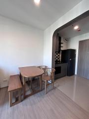 Modern kitchen with dining area, stylish cabinetry, and ample natural light