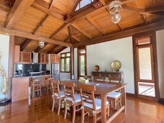 Spacious kitchen with wooden interior and dining table