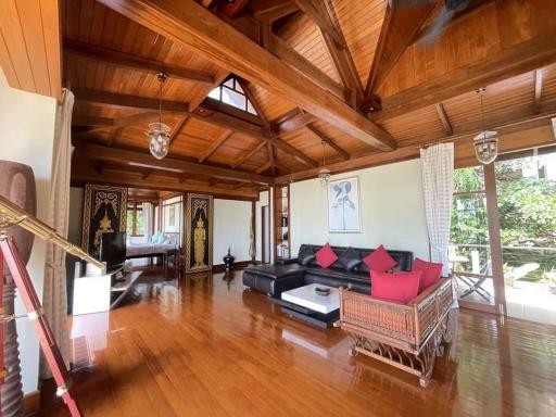 Spacious wooden themed living room with high ceilings and natural light