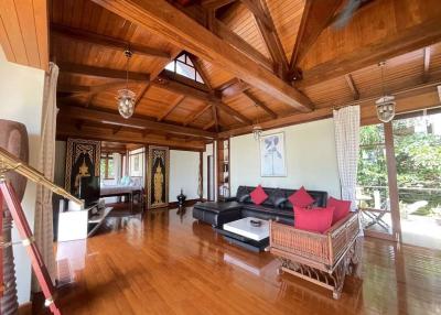Spacious wooden themed living room with high ceilings and natural light