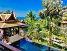 Luxury resort view with traditional architecture, pool, and ocean backdrop