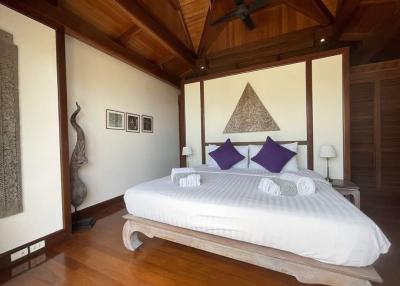 Spacious bedroom with wooden interior design and queen-sized bed
