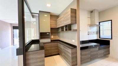 Modern kitchen with wooden cabinets and black countertops