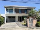 Modern two-story house with balcony and garage