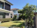 Modern two-story house with landscaped front yard in a suburban neighborhood