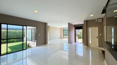 Spacious and bright living room with large windows and garden view