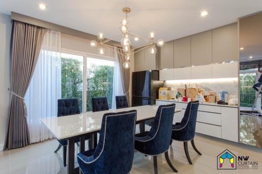 Elegant dining room with large table and modern chandelier