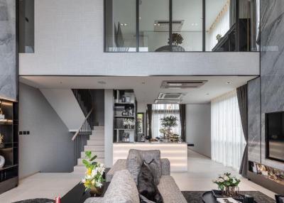 Spacious modern living room with high ceilings and mezzanine