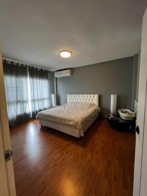 Cozy bedroom with queen-sized bed and hardwood flooring