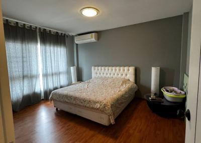 Cozy bedroom with queen-sized bed and hardwood flooring