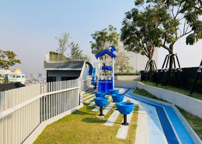 Rooftop playground with play structures and city views