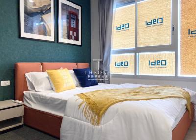 Cozy modern bedroom with a large bed, stylish bedding, and vibrant wall design
