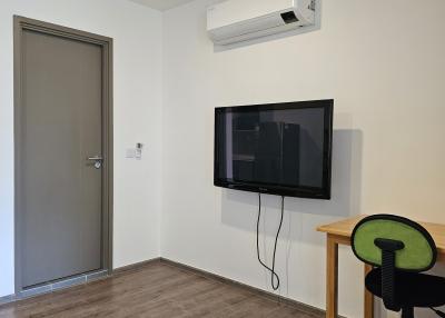 Minimalistic bedroom with air conditioning and mounted television