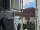 Balcony with a view of the sky and space for a washing machine