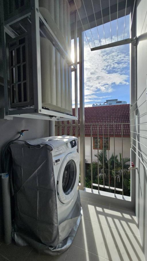 Balcony with a view of the sky and space for a washing machine