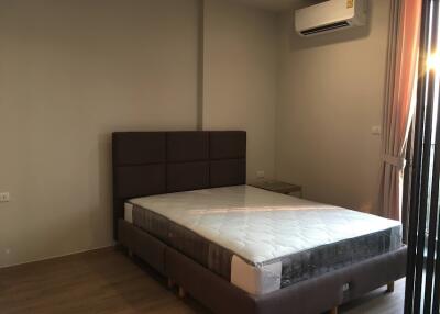 Spacious bedroom with large bed and modern air conditioning unit