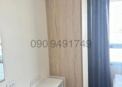Compact modern bedroom with wooden wardrobe and air conditioning unit