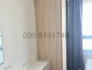 Compact modern bedroom with wooden wardrobe and air conditioning unit