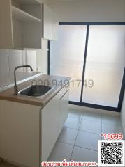 Modern kitchen with large window and white cabinetry