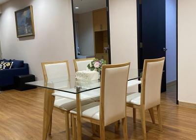 Modern dining area with wooden flooring and tasteful lighting