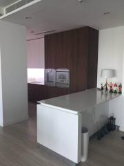 Modern kitchen with wooden cabinetry and integrated appliances