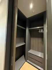 Interior of a modern closet with empty shelves and drawers