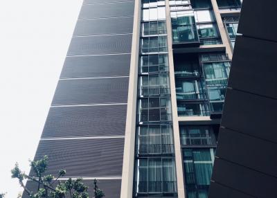 Modern high-rise residential building exterior with balconies and windows