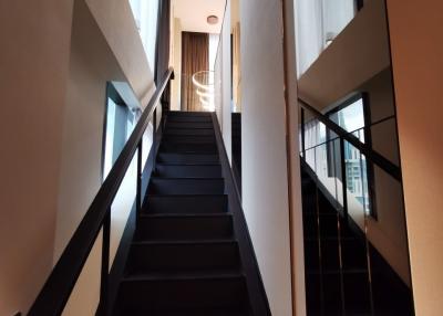 Modern staircase with dark steps and natural lighting