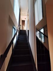 Modern staircase with dark steps and natural lighting