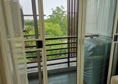 View from a balcony showing outdoor greenery and protective railings