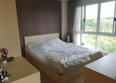 Modern bedroom with large window and natural light