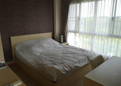 Cozy bedroom with large window and ample natural light