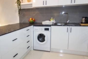 Modern kitchen with white cabinets and built-in appliances