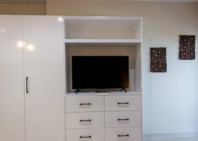 Modern living room interior with a flat-screen TV and white storage cabinets