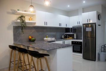 Modern kitchen with stainless steel appliances and breakfast bar