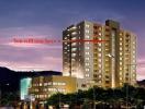 Twilight view of a modern residential building with illuminated windows