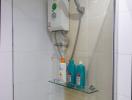 Modern electric shower system with toiletries on a glass shelf in a tiled bathroom
