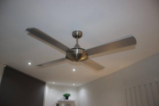 Contemporary living room with modern ceiling fan and recessed lighting