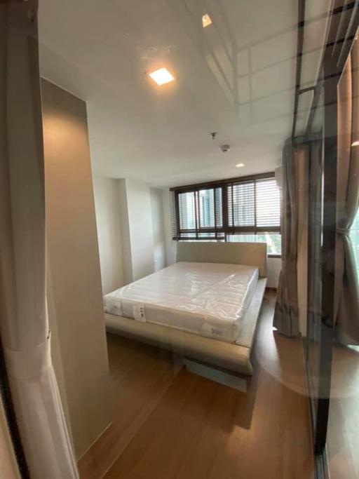 Spacious bedroom with large windows and new mattress