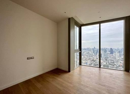 Bright and airy high-rise bedroom with a city view