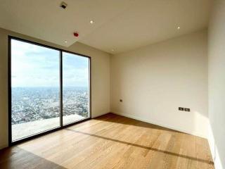 Minimalist bedroom with a large window offering a city view