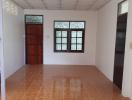 Empty interior space with terracotta tiles and white walls